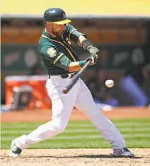  ?? Ben Margot / Associated Press ?? Jonathan Lucroy hits a single in the sixth for one of his four RBIs as the A’s swept a three-game series from Toronto.