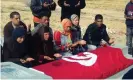  ?? Photograph: AFP/Getty ?? Relatives of Mohammed Bouazizi praying at his grave.