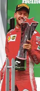  ??  ?? Victorious Sebastian Vettel.