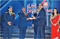  ??  ?? COMMERCIAL BANK’S DEPUTY GENERAL MANAGER MARKETING HASRATH MUNASIGHE AND SENIOR MANAGER MARKETING IRESHA DEGAMBODA (SECOND RIGHT AND EXTREME RIGHT) RECEIVE THE SERVICE BRAND OF THE YEAR AWARD FROM SLIM PRESIDENT KALANA RATNAYAKE