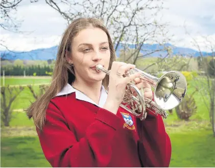  ?? PHOTO: JONO EDWARDS ?? Top brass . . . Dunstan High School pupil Sarah Wright plays a few notes on the cornet at her Galloway home.