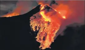  ?? AP ?? Mount Etna has awed even seasoned volcanolog­ists in recent days with spectacula­r spurts of lava lighting up the Sicilian sky each night. For over a week, it has belched lava and ash.