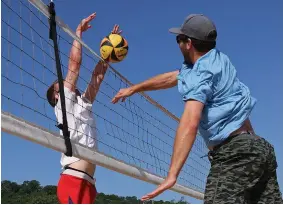  ?? ?? Middle: Mason McCrury, left, and Logan Corley play beach volleyball on the courts at Murray Park.