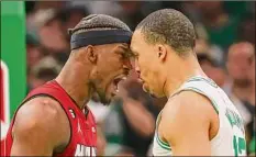  ?? Adam Glanzman / TNS ?? The Heat’s Jimmy Butler, left, exchanges words with the Celtics’ Grant Williams during the fourth quarter in Game 2 of the Eastern Conference finals on Friday in Boston.
