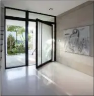  ?? ROBIN HILL/TOUZET STUDIO VIA AP ?? This undated photo provided by Touzet Studio shows an entryway in a Florida home by Touzet Studio. Designer Jacqueline Gonzalez Touzet says terrazzo flooring, as seen here, is a great choice due to its durability and long-lasting beauty.