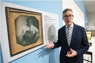  ?? AP Photo/Steve Helber ?? ■ Erik H. Neil, director of the Chrysler Museum of Art, gestures next to a portrait of enslaved woodworker John Hemmings during a tour of an exhibit titled “Thomas Jefferson, Architect: Palladian Models, Democratic Principles, and the Conflict of Ideals” on Oct. 16 at the museum in Norfolk, Va. Hemmings was a brother of Sally Hemings, an enslaved woman whom scholars say had children with Jefferson. The siblings spelled their last names differentl­y.