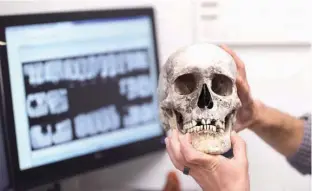  ?? Associated Press ?? Dr. Tim Gocha uses dental records on April 12 at the Forensic Anthropolo­gy Center at Texas State University in San Marcos, Texas, as he works to help identify the remains of an immigrant who died along the U.S-Mexico border. Forensic investigat­ors and...
