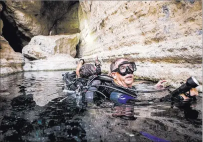  ?? Patrick Connolly ?? Las Vegas Review-journal @Pconnpie Mal Maloney, scuba trainer and safety diver at Death Valley National Park, prepares to submerge for a biannual count of the Devils Hole pupfish at Devils Hole on April 7.