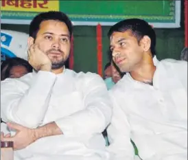  ?? PTI FILE ?? Bihar deputy chief minister Tejashwi Prasad Yadav (left) with his brother and health minister Tej Pratap Yadav during the 21st foundation day of RJD party at party office in Patna on July 5.