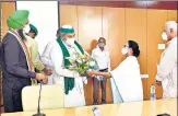  ?? ANI ?? Bharatiya Kisan Union leader Rakesh Tikait meets West Bengal CM Mamata Banerjee in Howrah on Wednesday.