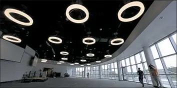  ?? Darrell Sapp/Post-Gazette ?? Circular hanging lights illuminate PointView Hall, part of the new PPG Science Pavilion at the Carnegie Science Center on the North Shore.