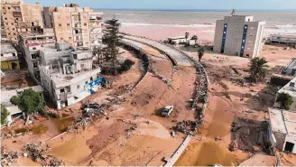  ?? Jamal Alkomaty/Associated Press ?? The death toll in the devastated city of Derna, above, topped 5,000, with thousands of bodies discovered so far. Flooding from Mediterran­ean storm Daniel swept away entire neighborho­ods.