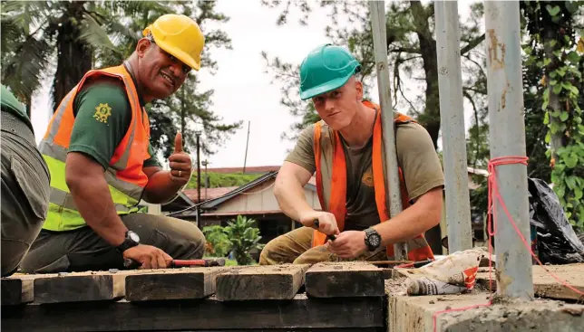  ?? Photo: Corporal Matthew Kenny ?? Australian Army soldier Sapper Logan Kocbek, from 2nd Combat Engineer Regiment, and an RFMF engineer secure timber decking during constructi­on of the footbridge.