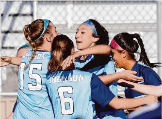  ?? Ronald Cortes/contributo­r ?? Johnson’s Camila Palacios celebrates with teammates after scoring early in the first half Tuesday against Reagan. Palacios has combined with Mabry Williams to score 46 goals on the season.