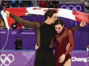  ?? JAMIE SQUIRE / GETTY IMAGES ?? Gold-medal winners Tessa Virtue and Scott Moir of Canada celebrate during the victory ceremony for the figure skating ice dance free dance.