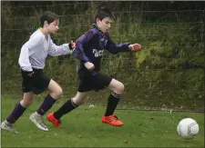  ??  ?? Cillian Egan of Courtown Hibs is pursued by Conor Cullen.