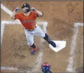  ?? Associated Press ?? The Astros’ Jose Altuve celebrates after hitting a home run against the Texas Rangers during the third inning in Game 3 of the AL Championsh­ip Series, Wednesday, in Arlington, Texas.