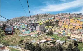  ?? ?? ‘Transmicab­le’ cable car carriages pass above Ciudad Bolivar neighbourh­ood in Bogota.