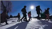  ?? ROBERT F. BUKATY — THE ASSOCIATED PRESS ?? On Dec. 8, CIndy Soule’s fourth grade class heads outsIde to study snowflakes at the Gerald Talbot School In Portland, MaIne.