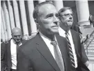  ?? AP PHOTO BY MARY ALTAFFER ?? Republican U.S. Rep. Christophe­r Collins, center, leaves federal court Wednesday in New York.