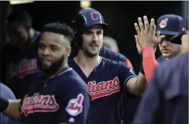  ?? CARLOS OSORIO — THE ASSOCIATED PRESS ?? The Indians’ Lonnie Chisenhall is greeted in the dugout after scoring from second on a double by Abraham Almonte during the fifth inning.