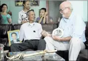  ?? KHA HOA/ASSOCIATED PRESS ?? Dr. Sam Axelrad (right) shakes hands with former North Vietnamese soldier Nguyen Quang Hung at Hung’s house in the town of An Khe, Gia Lai province, Vietnam on Monday.