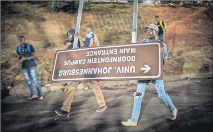  ?? Photo: Daylin Paul ?? Sign of the times: Students uprooted a sign to use as a barricade outside the University of Johannesbu­rg’s Doornfonte­in campus after a charged confrontat­ion with security guards this week.