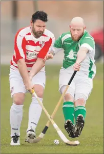  ?? Photograph­s: Neil Paterson. ?? Beauly’s MacKay Murray gets his block in on Lochaber’s John MacKenzie.