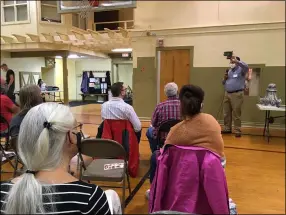  ?? ?? Lorain architect Gary Fischer holds up an architectu­ral feature during his talk inside the historic Wellington Village Hall on Sept. 22.