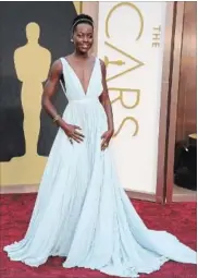  ?? JORDAN STRAUSS INVISION/AP ?? Lupita Nyong’o, in a light blue Prada gown, won the Oscar for best supporting actress for her role in “12 Years a Slave.”