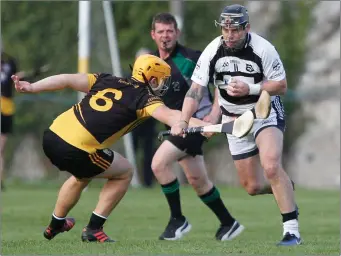  ??  ?? Ballyhea’s Neil Ronan breaks past the challenge of Fermoy’s Trevor Grumbridge during last weekend’s Division 2 Hurling League semi-final replay in Buttevant. Photo by Eric Barry