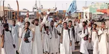  ?? | AFP ?? SUDANESE protesters gather at Sudan’s port this week. Dozens of demonstrat­ors blocked key roads and in protest at parts of a peace deal with rebel groups.