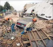  ?? Spencer Weiner associated Press ?? RESCUE WORKERS uncover cars after an earthquake struck Paso Robles, Calif., in December 2003.