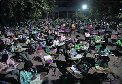  ?? Mahesh Kumar / AP Photo ?? Bookworms bring their own chairs, which they chain to the metal gates of the Hyderabad building overnight.