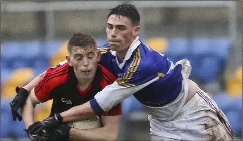  ??  ?? Robbie Brooks of Castletown and Coláiste Bhríde (Carnew) challenges Darragh Fitzgerald in the Wicklow schools final.