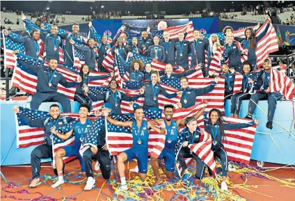  ??  ?? Flying the flag: The victorious United States team celebrate their success at the Athletics World Cup in London Stadium