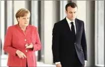 ?? PICTURE: REUTERS ?? German Chancellor Angela Merkel and French President Emmanuel Macron on their way to a news conference at the building site of the Humboldt Forum in Berlin, Germany.