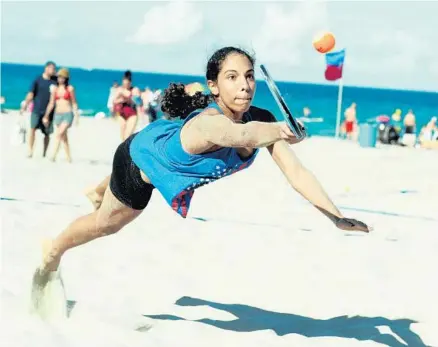  ?? PHOTO BY GARY CURRERI ?? Pembroke Pines’ Megan Horwitz lunges to return a shot during the recent Deerfield Beach World Cup Beach Tennis event. Horwitz and her partner, Karla Mendez, will represent the United States at a world championsh­ip tournament in Spain this week.