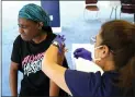  ?? LYNNE SLADKY — THE ASSOCIATED PRESS ?? Student Rose Jean-mary, 19, receives a shot of the Pfizer COVID-19 vaccinatio­n from registered nurse Isabel Ruiz, right, Friday at St. Thomas University in Miami.