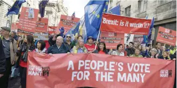  ?? — AFP ?? Protesters hold placards as they take part in an anti-brexit, pro-eu march through the centre of Liverpool, north west England on Sunday, in support of a People’s Vote.