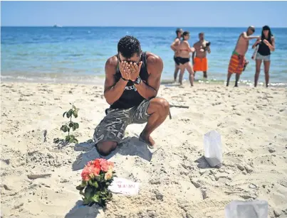  ?? Picture: Getty Images. ?? A local man grieving at the scene of the beach attack shortly after the tragedy.