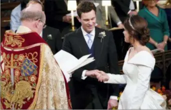  ?? DANNY LAWSON — POOL VIA AP ?? Britain’s Princess Eugenie and Jack Brooksbank during their wedding ceremony in St. George’s Chapel, Windsor Castle, near London, England, Friday.