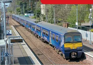  ?? ?? No. 320306 leads No. 320415 on a Balloch-Airdrie service on approach to Bowling on April 22, 2021.