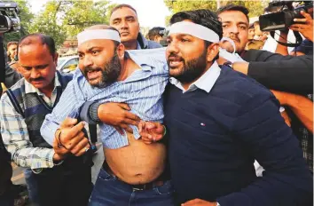  ?? AP ?? Policemen in plaincloth­es detain an activist of Congress party’s youth wing during a protest against the Citizenshi­p Amendment Act at Gandhi Ashram in Ahmedabad, Gujarat, yesterday.