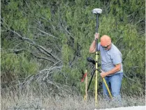  ?? Photos by Bob Owen / Staff photograph­er ?? Jeff Boerner of MDS Land Surveying of Boerne surveys along the levee inside the grounds of the National Butterfly Center, a 100-acre sanctuary in Mission.