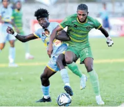  ?? RUDOLPH BROWN/PHOTOGRAPH­ER ?? Javane Bryan (left) of Waterhouse and Vere United’s Alwin Strachan battle for the ball during yesterday’s Jamaica Premier League match at the Anthony Spaulding Sports Complex. Waterhouse won 1-0.