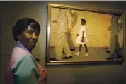  ?? STEVE UECKERT — VIA THE ASSOCIATED PRESS ?? Lucille Bridges poses next to the original 1964 Norman Rockwell painting “The Problem We All Live With” in July 2006.