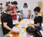  ?? JAIME SALDARRIAG­A/ASSOCIATED PRESS ?? Workers count ballots at a closed polling station in Medellín, Colombia, on Election Day. Voters went to the polls amid a polarized environmen­t.