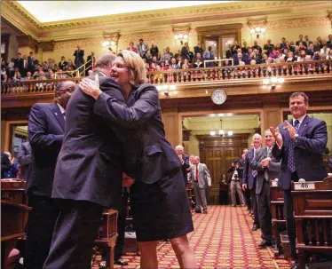  ?? BOB ANDRES / BANDRES@AJC.COM 2010 ?? Speaker Pro Tem Jan Jones, R-Alpharetta, is congratula­ted during her official entrance to the House chamber after being selected for that office in 2010, a rarity for a woman in the Georgia Legislatur­e. Few women have attained senior leadership roles in the male-dominated General Assembly over the years.