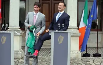  ?? PAUL FAITH/AFP/GETTY IMAGES ?? Justin Trudeau receives an Ireland rugby shirt and a pair of socks from Irish Prime Minister Leo Varadkar.